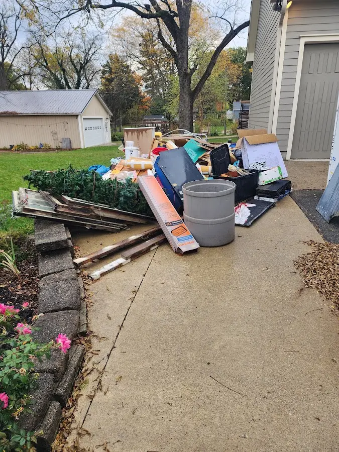 Dumpster being loaded with debris for 3 Yard Dumpster Rental in Quincy